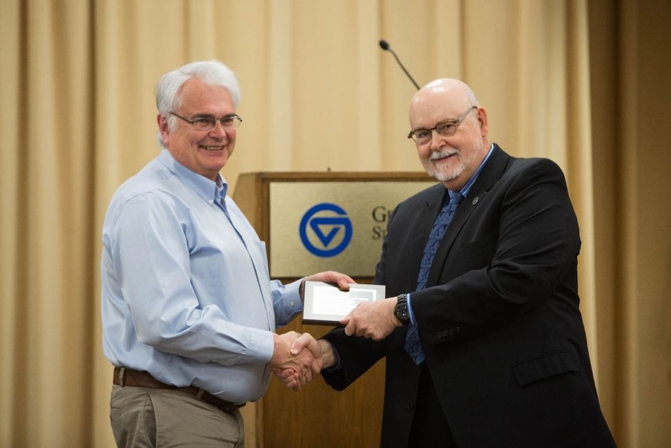 Rick Rediske receives a service award from CLAS Dean Antczak